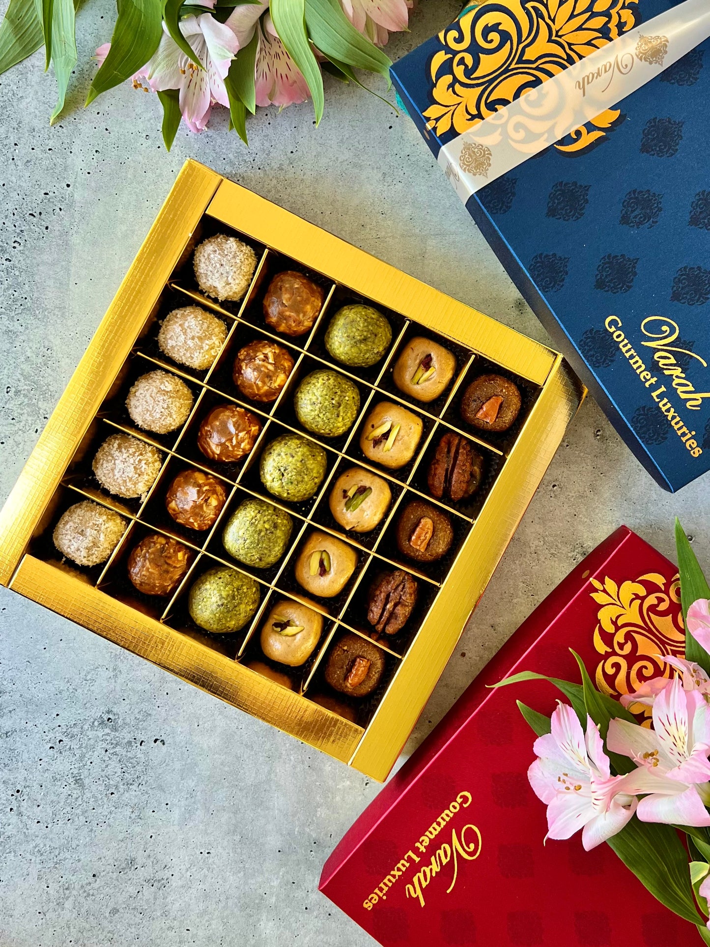 25 Fruit & Nut bites in a gold foiled gift box wrapped with a satin ribbon