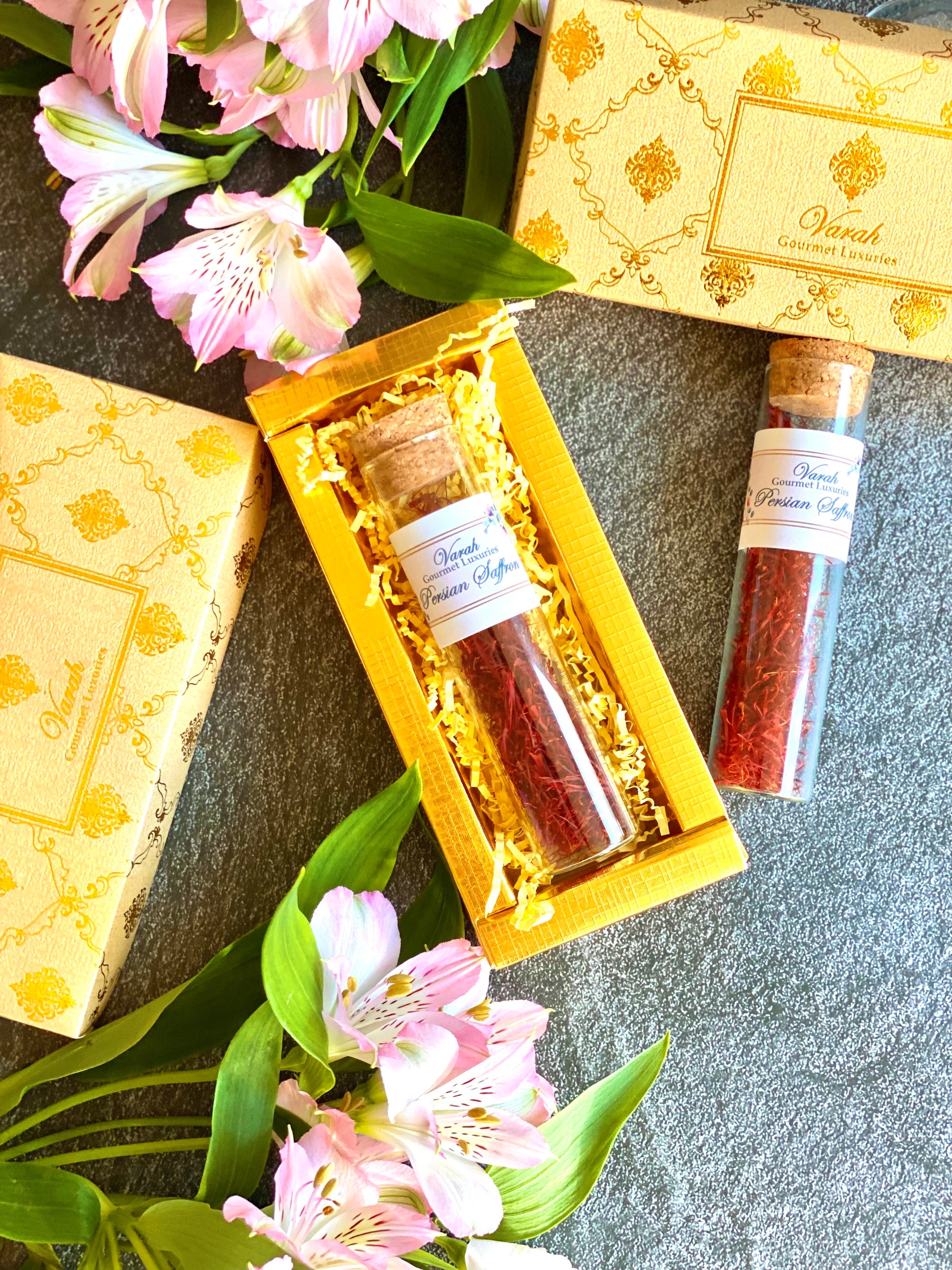 Glass tube filled with premium saffron in a gold foiled gift box